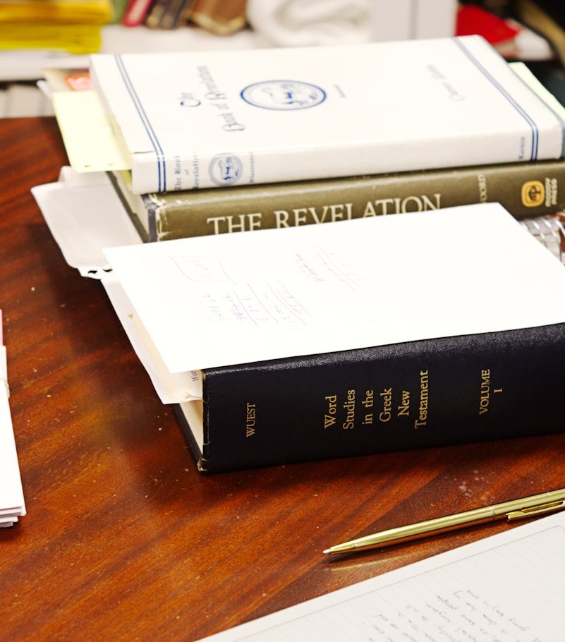 four person hands wrap around shoulders while looking at sunset