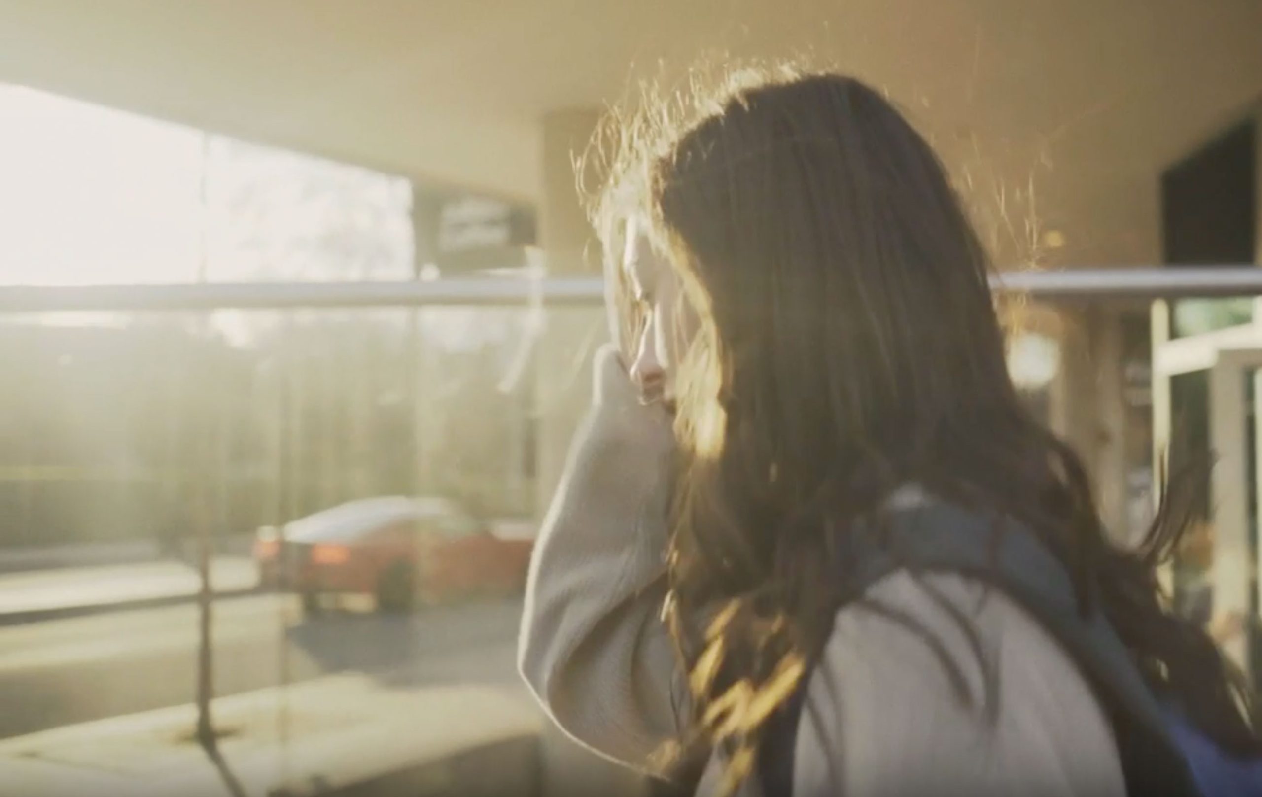 woman wearing blue denim jacket holding book